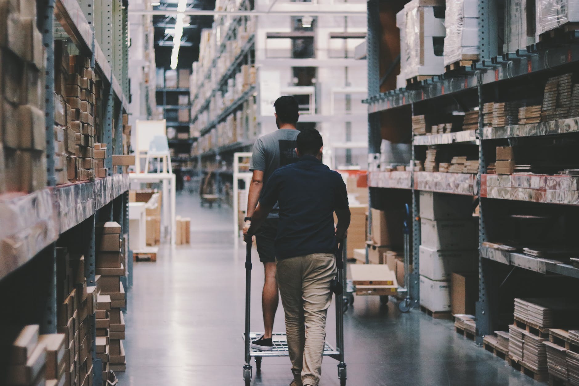 men going around a warehouse